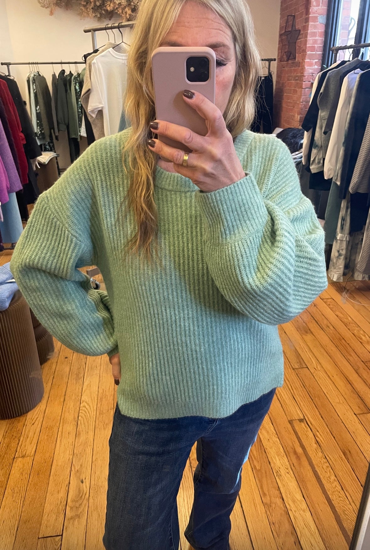 person wearing a mint green jumper